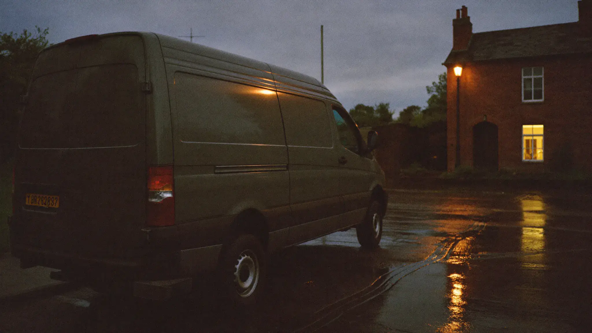 A tradesman's van parked on a Dublin street at blue hour