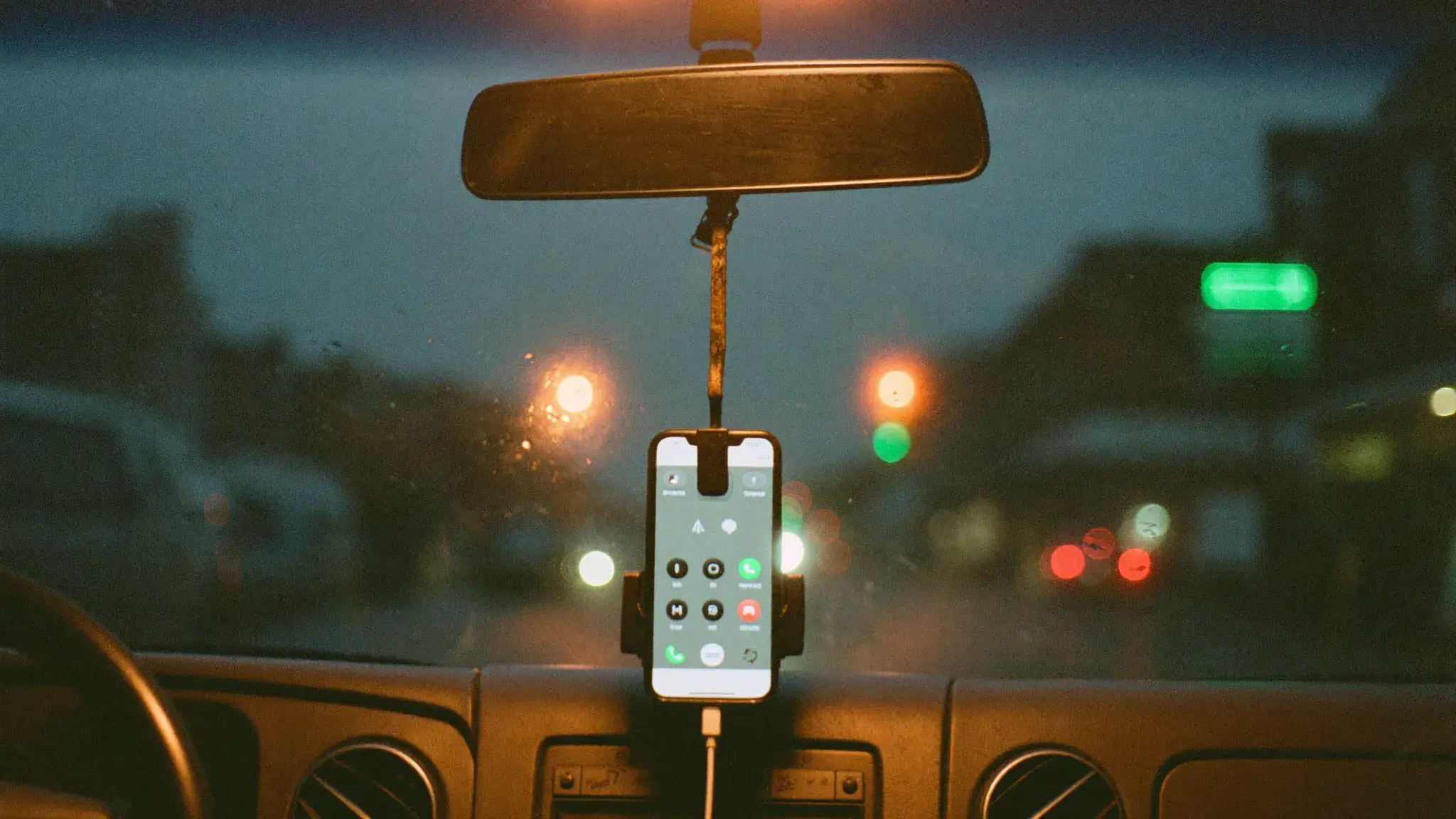 A phone on a van dashboard at dusk with a call connected